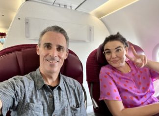 Maise and Greg flying Business Class